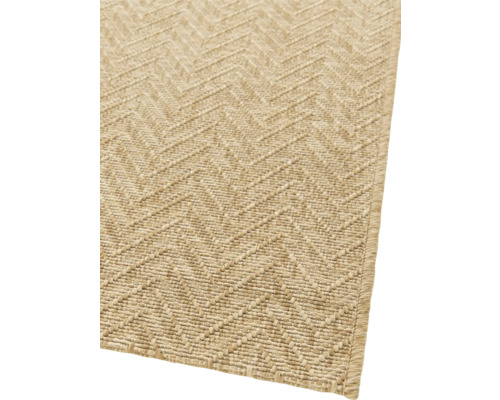 Detailansicht eines beigen Teppichs mit Zickzackmuster