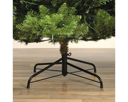 Gros plan d'un sapin de Noël artificiel avec un pied en métal