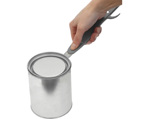 Un ouvre-couvercle de pot de peinture ouvre un pot de peinture