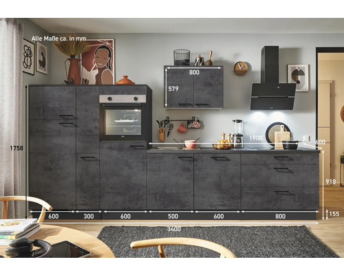 Cuisine en béton foncé avec divers placards et appareils électriques intégrés.