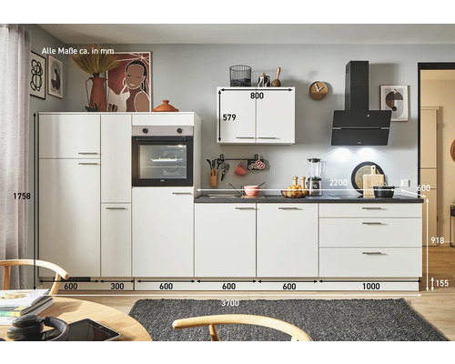 Cuisine moderne avec armoires et tiroirs blancs, ainsi qu''un four intégré et une hotte aspirante.