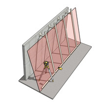 Laser de chantier sur trépied pour l'alignement vertical d'éléments muraux et de supports sur un mur en béton.