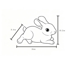 Dessin au trait d'un lapin couché avec dimensions : 16 centimètres de longueur, 10,2 centimètres de hauteur et 8,4 centimètres de largeur.